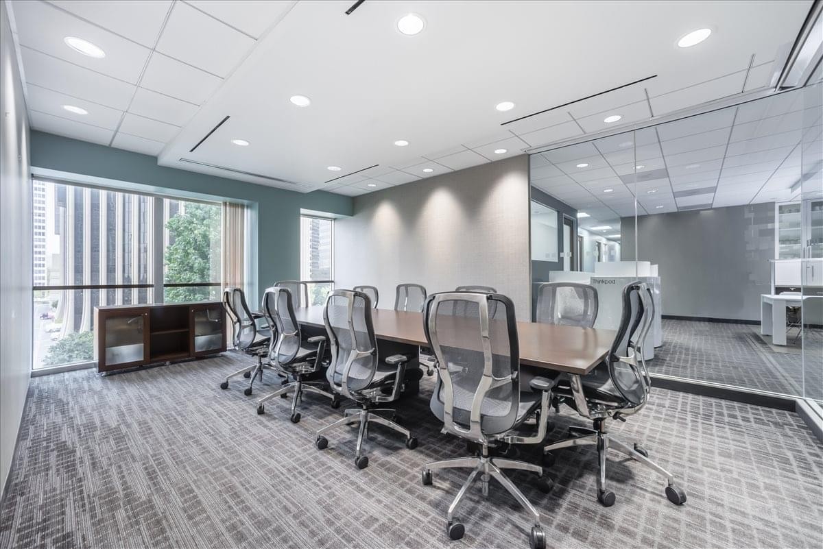 Modern conference room at 2029 Century Park East, Suite 400N featuring a long table and mesh chairs.