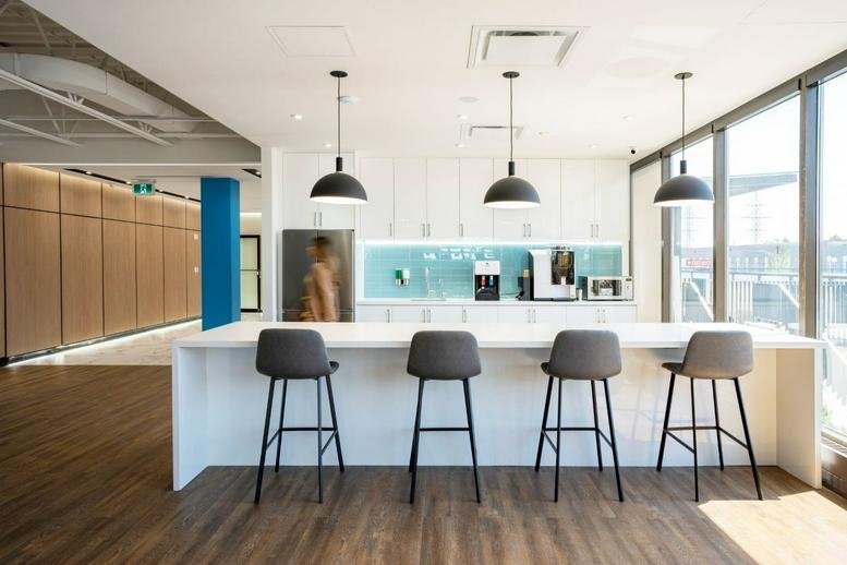 Modern communal kitchen and cafe area at 205 Placer Court, North York.