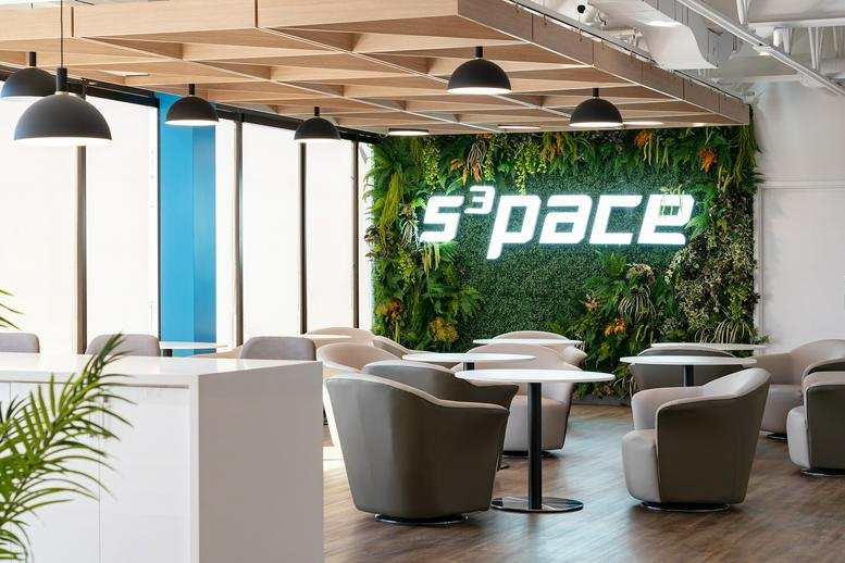 Lounge at 205 Placer Court, North York featuring a green plant wall with illuminated S3pace branding.