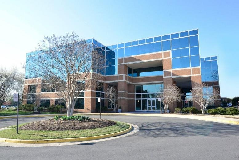 Exterior view of the brick and glass office building at 205 Van Buren Street.