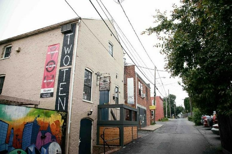 Exterior view of the brick building at 210 West Grant Street with vibrant mural art.