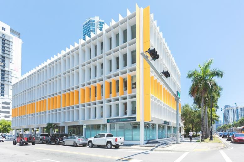 Exterior view of the white and yellow building at 2125 Biscayne Boulevard Miami, Florida.