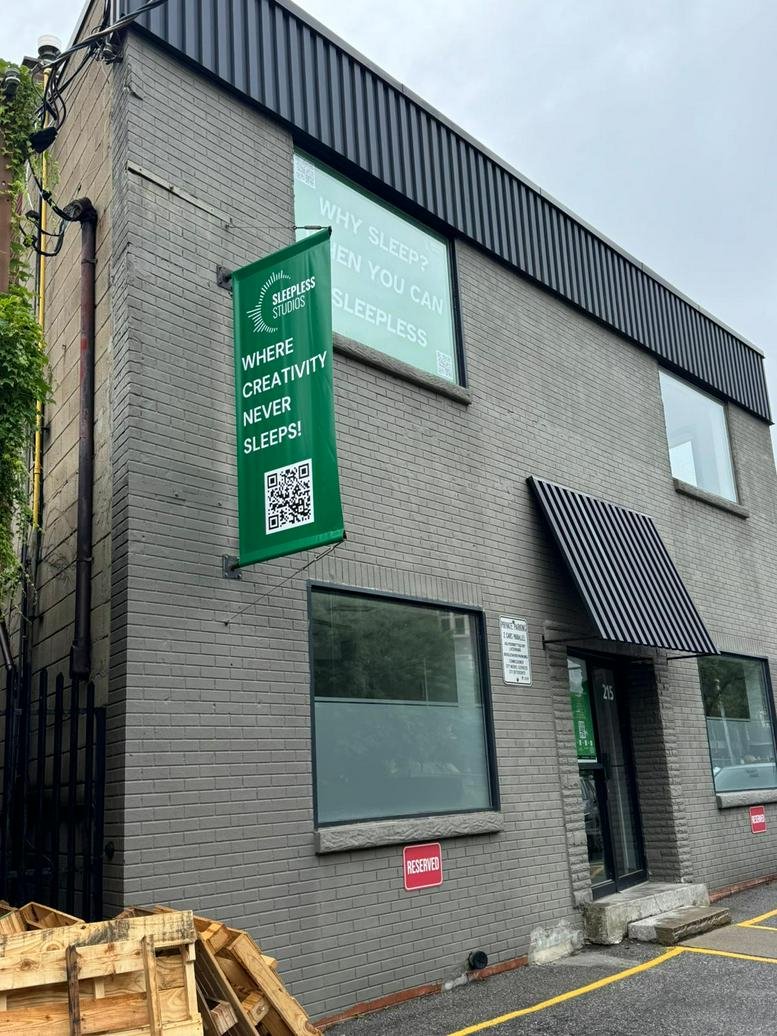 Exterior view of the grey brick industrial building at 215 Niagara Street.