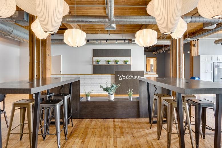 Spacious reception area with warm lighting and wooden ceilings at 215 Spadina Avenue.