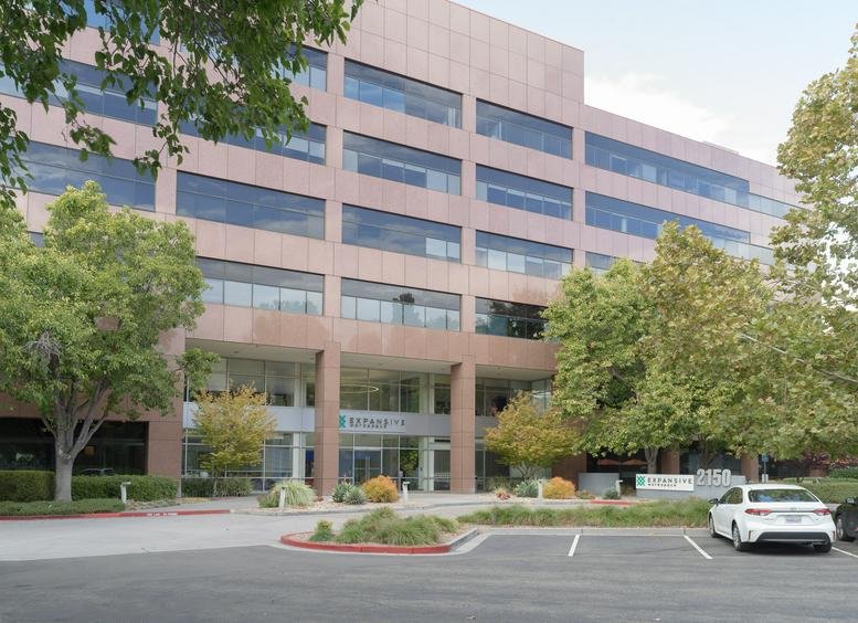 Exterior view of the multi-story glass and stone building at 2150 N 1st St, San Jose (California).