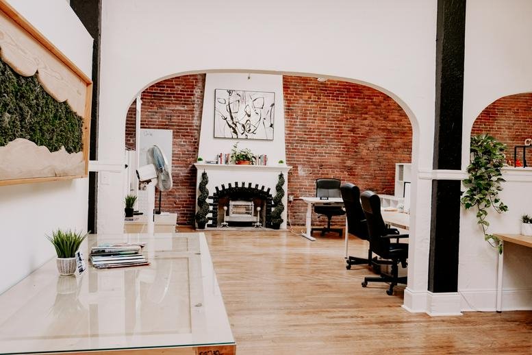 Light-filled interior showing a white fireplace mantel and arched doorway at 216 Commercial Street North East.