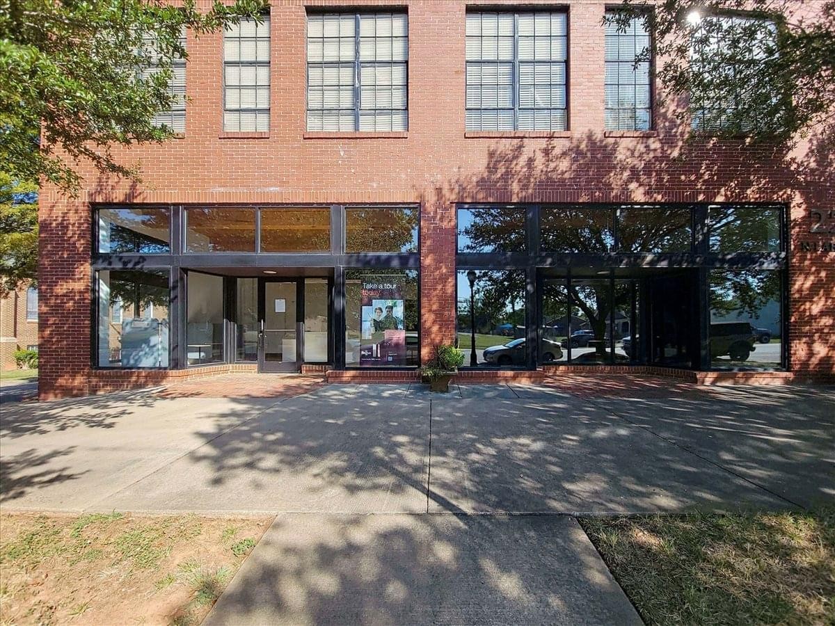 Exterior brick facade of the 222 North Lafayette Street building with large storefront windows.