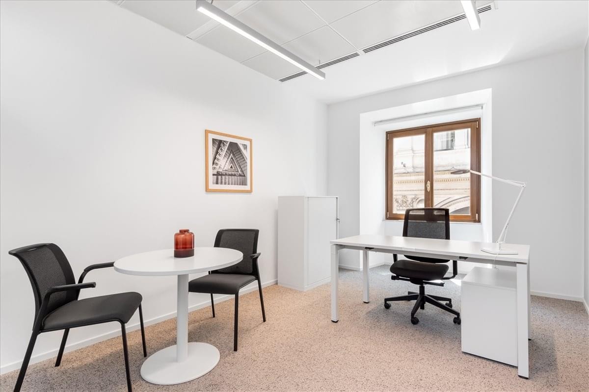 Private office suite at 222 South Prospect Avenue with a desk and meeting table.
