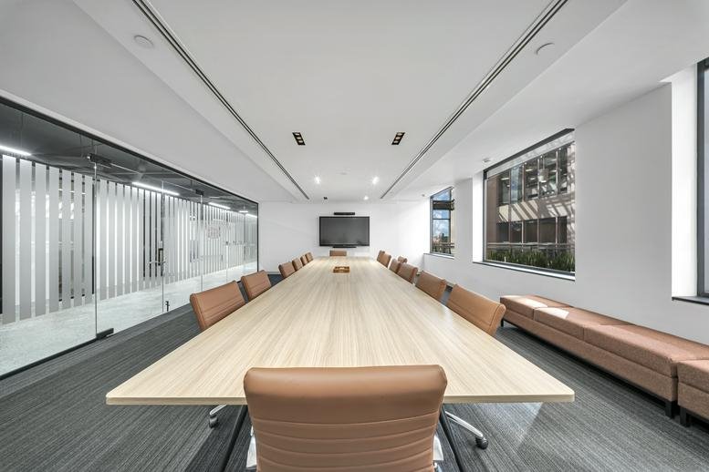 Spacious boardroom at Workplace K, Suite 700, 225 East Beaver Creek Road with a long wood table and tan leather chairs.