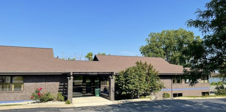Exterior view of the low-rise brown brick building at 2300 Riverside Drive, Green Bay, Wisconsin.