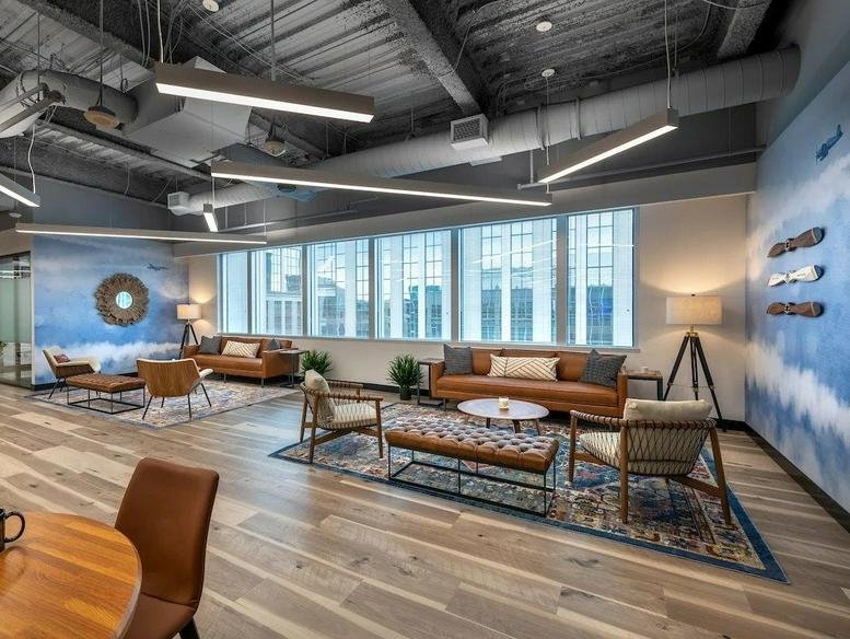 Spacious lounge area at 2300 Wilson Boulevard Suite 700, Arlington (Virginia) with leather sofas and blue mural.