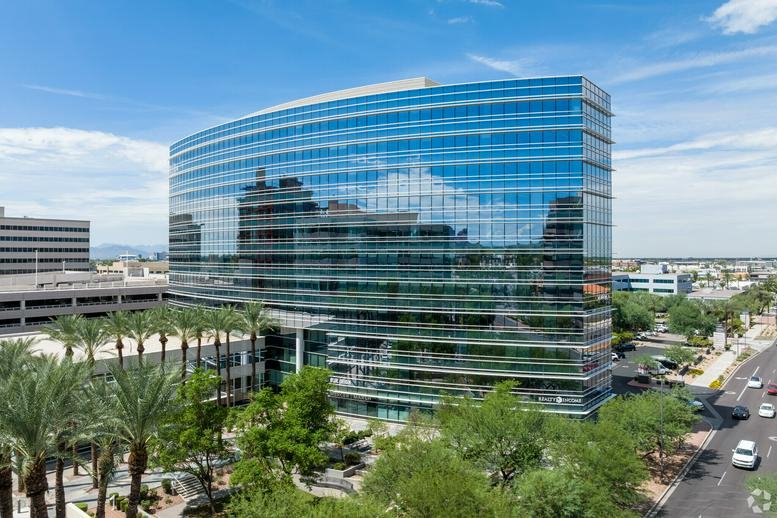 Exterior view of the blue glass office building at 2325 East Camelback Road, Suite 400.