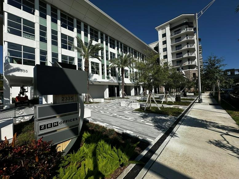 Exterior view of the modern white office building at 2335 East Atlantic Boulevard, Suite 200 and 300.