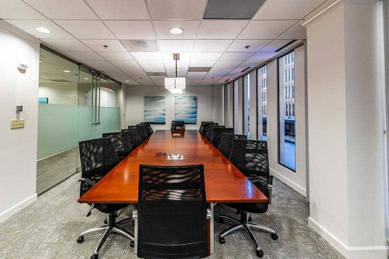 Spacious boardroom at 235 Peachtree Street with a long wood table and mesh chairs.