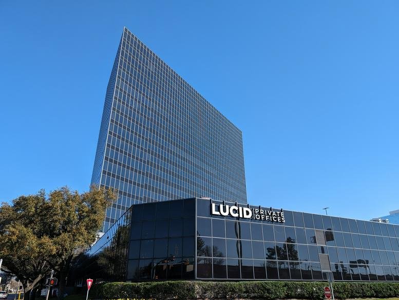 Exterior view of the glass-facade 24 Greenway Plaza building with Lucid Private Offices signage.