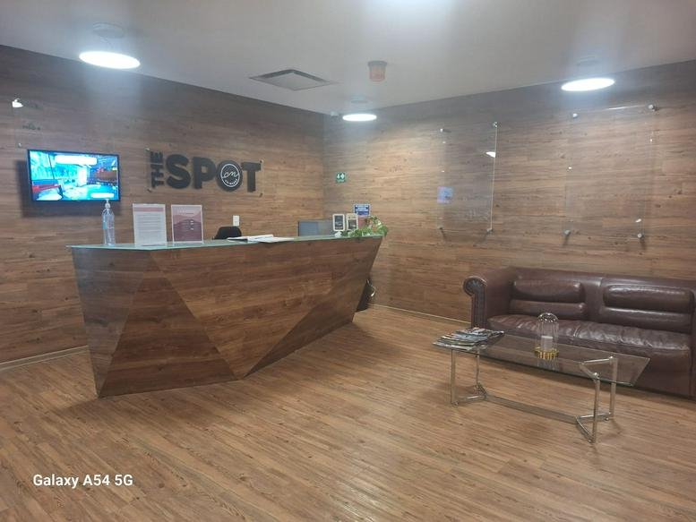Wood-paneled reception area for THE SPOT at 2430 Carretera México-Toluca.
