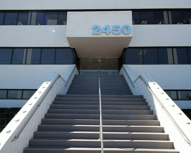 Exterior facade and grand entrance staircase of 2450 NASA Parkway.