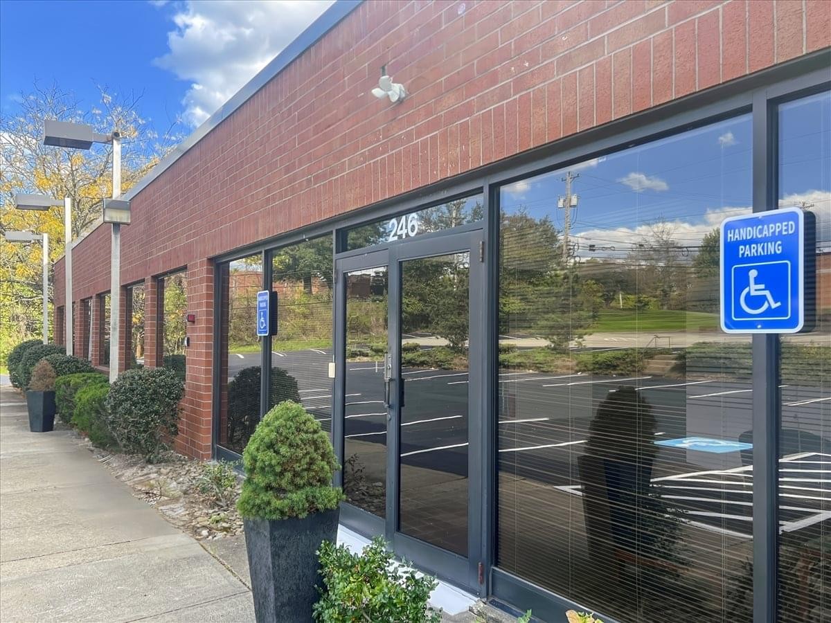 Exterior view of the red brick building at 246 Alpha Drive.