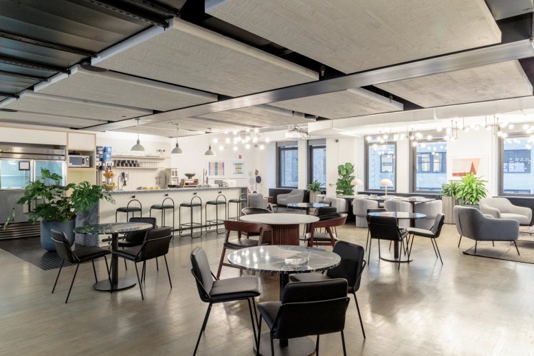 Spacious communal lounge and kitchen area at 25 Broadway, 10th Floor, New York City.