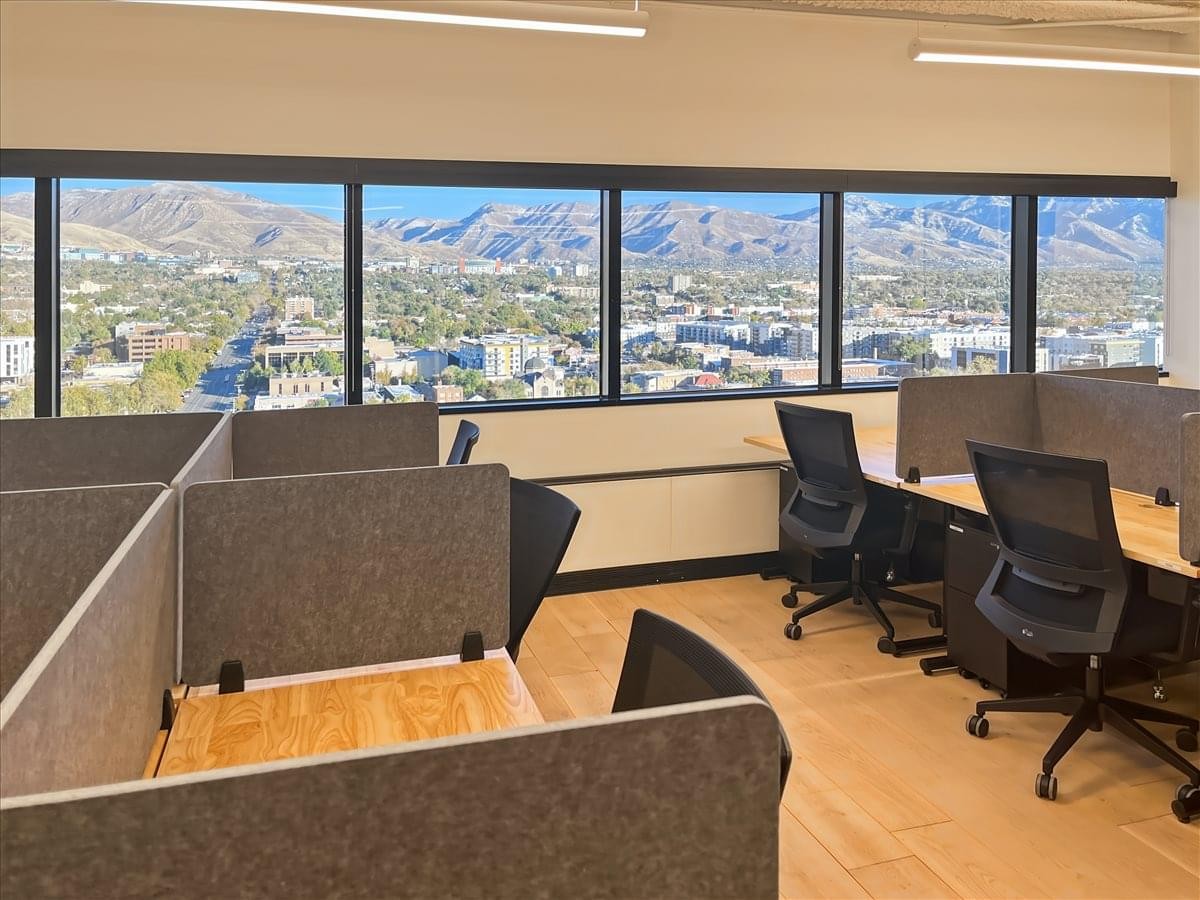 Spacious open workspace at 250 E 200 South with modern desks and expansive city and mountain views.