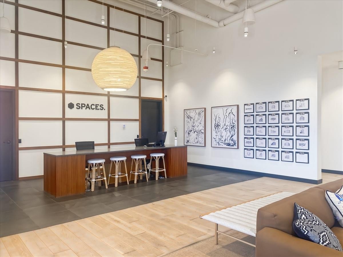 Reception area at 250 E 200 South with a wood-panelled desk and branded feature wall.