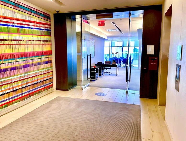Spacious reception area at 250 West 55th Street with a colorful thread art feature wall.