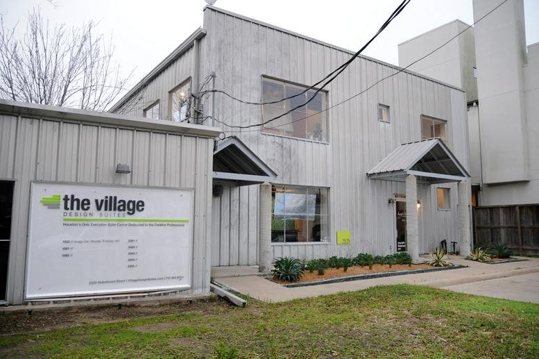 Exterior view of the light grey building facade at 2525 Robinhood Street.