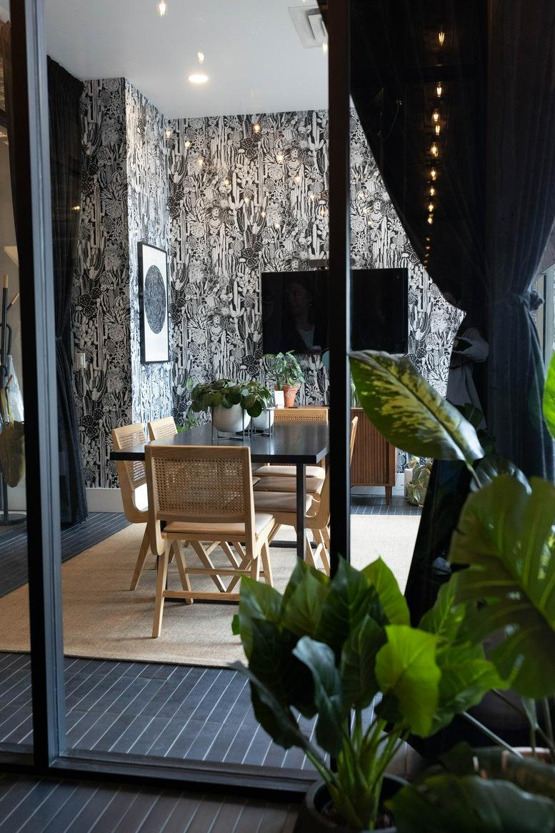 A modern dining area with pattern wallpaper and wooden chairs at 26 South Rio Grande Street, The Gateway.