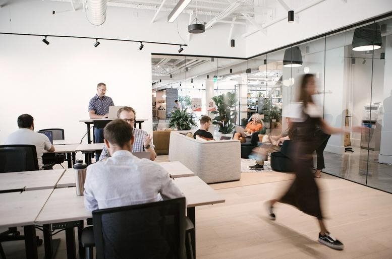 Bright open-plan office at 26 South Rio Grande Street, The Gateway, featuring various workstations and plants.