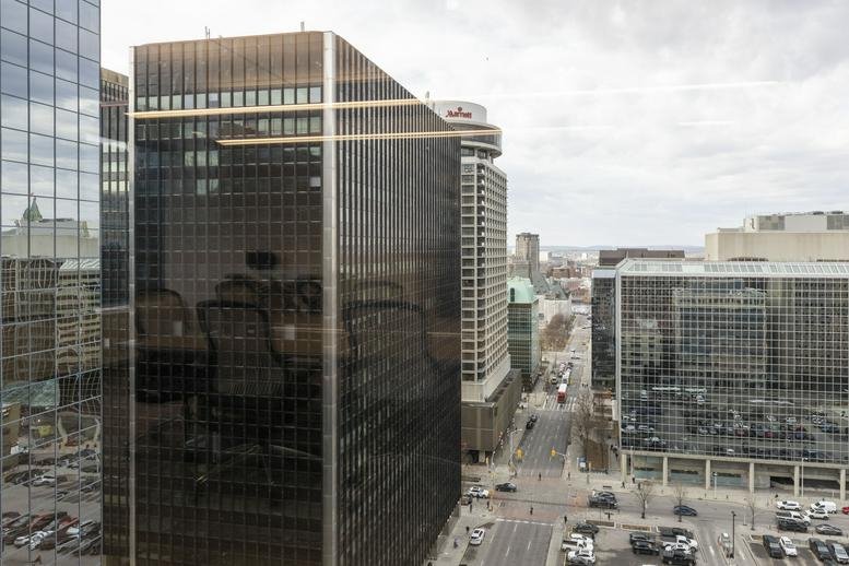 Exterior view of the dark glass facade and entrance at 275 Slater Street.