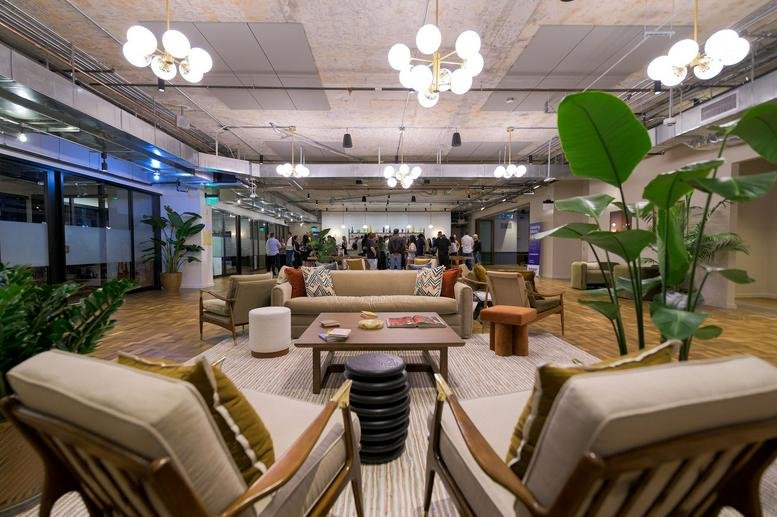 Spacious communal lounge at 2916 North Miami Avenue with modern seating and warm globe lighting.