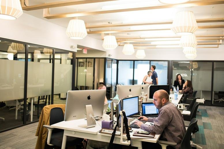 Spacious open-plan workspace at 2920 W Broad St, Richmond (Virginia) with modern lighting and glass-walled offices.