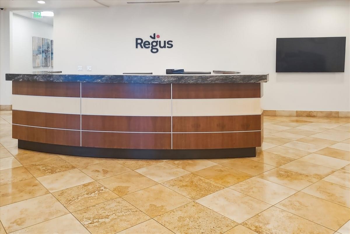 Reception area at 300 E 2nd Street, 15th Floor, Reno, Nevada featuring a curved wood and marble desk.