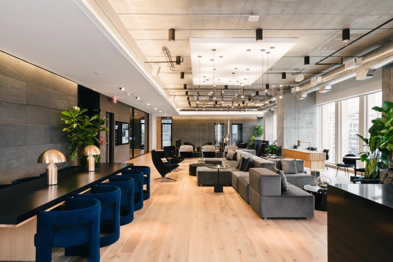 Spacious communal lounge at 31 Hudson Yards with velvet chairs, wood floors, and modern lighting.
