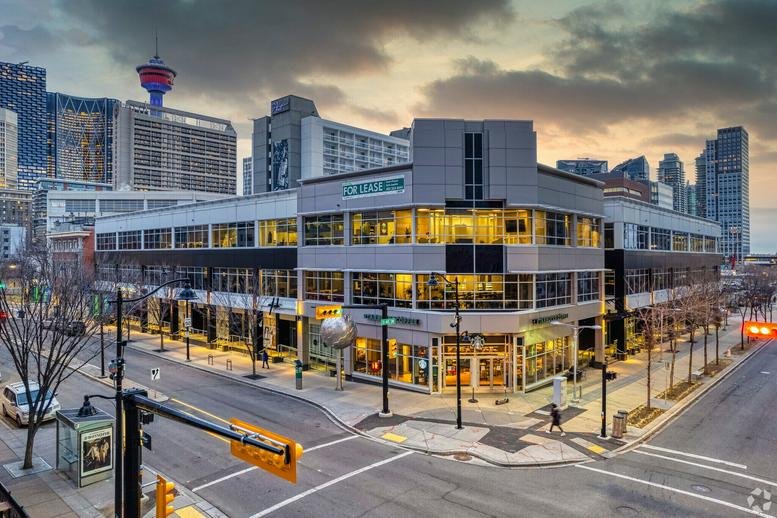 Exterior view of the modern mixed-use building at 310, 150 13th Avenue South West under a sunset sky.