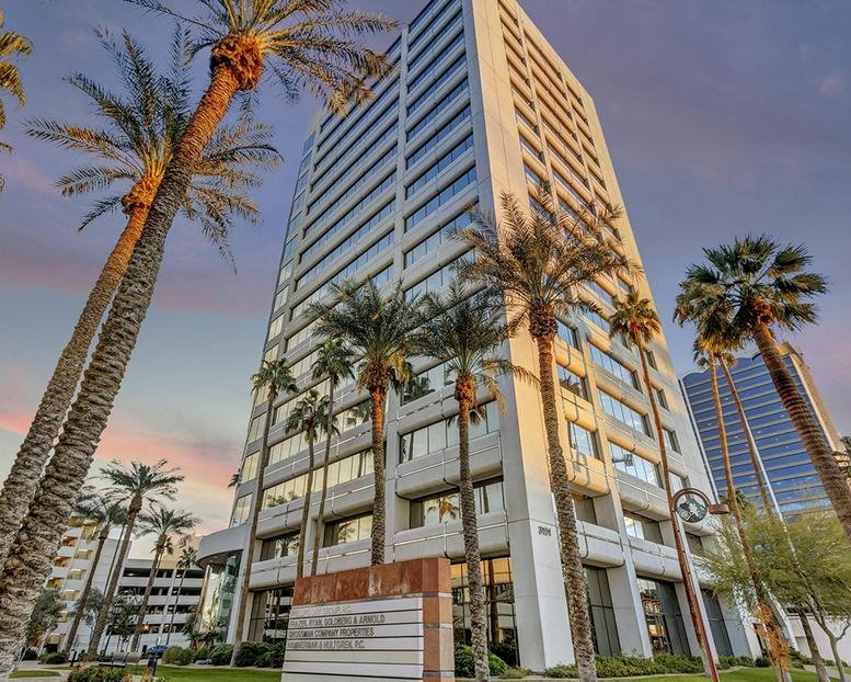 Exterior view of the white high-rise office building at 3101 N Central Avenue with palm trees.