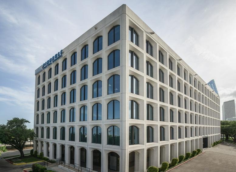 Exterior view of the white, grid-facade building at 3120 Southwest Freeway.