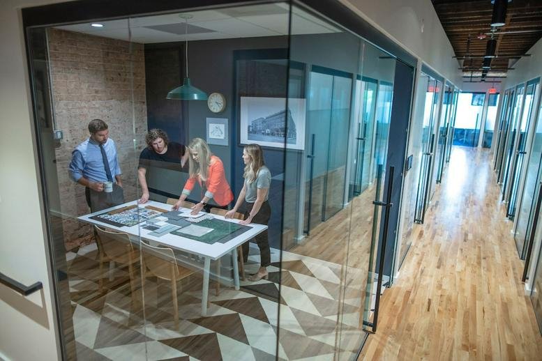Spacious glass-walled meeting room with industrial-chic design at 313 East Broad Street, Richmond (Virginia).
