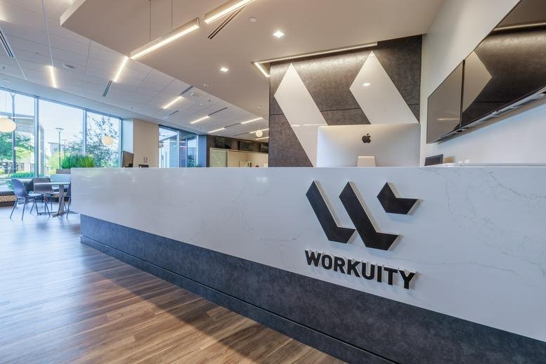 Polished reception desk at 3133 West Frye Road, Suite 101, Chandler featuring bold branding.