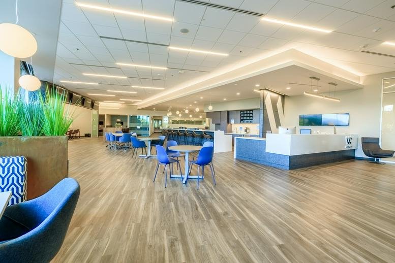 Expansive common area at 3133 West Frye Road, Suite 101, Chandler (Arizona) with blue chairs and wood floors.