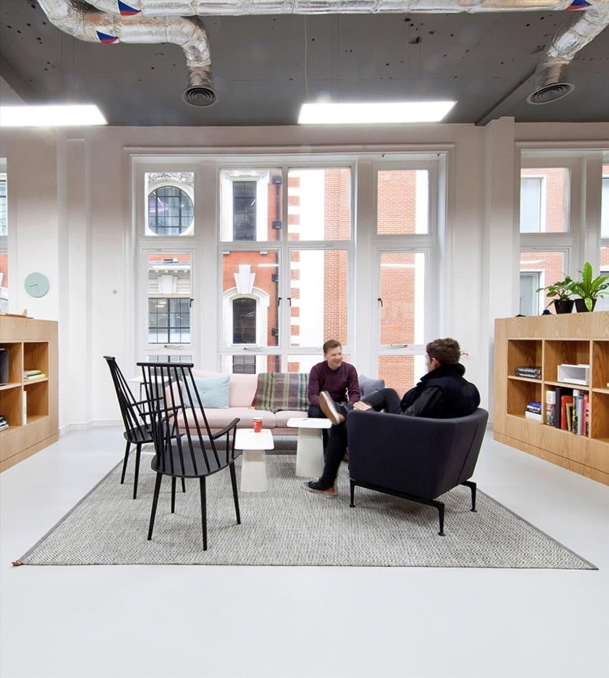 Spacious communal lounge in the Canada Permanent Trust Building with modern furniture and large windows.