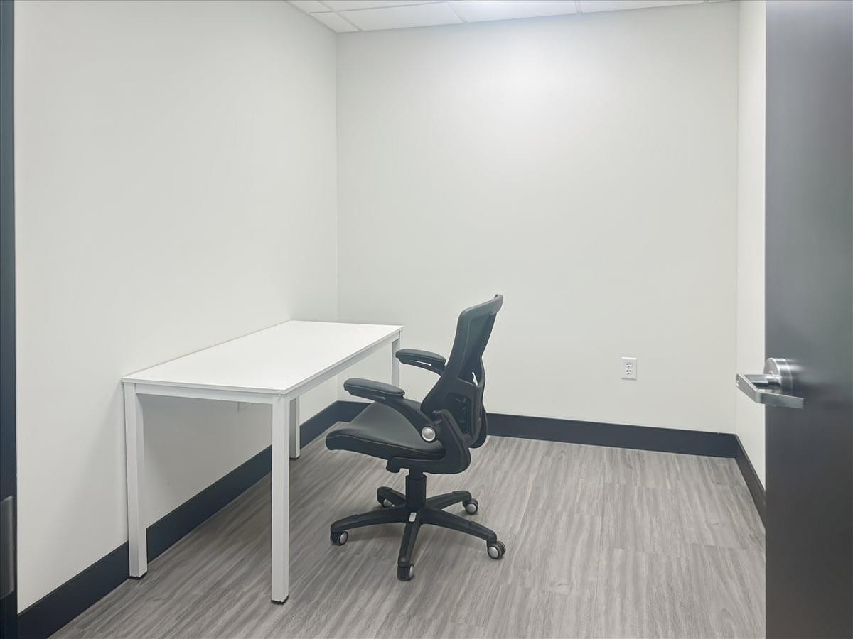 Private office suite at 3293 Harrison Boulevard featuring a white desk and ergonomic chair.