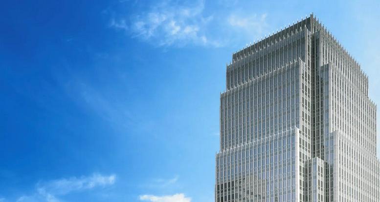 Modern glass exterior of the 33 North Dearborn Street skyscraper against a blue sky.