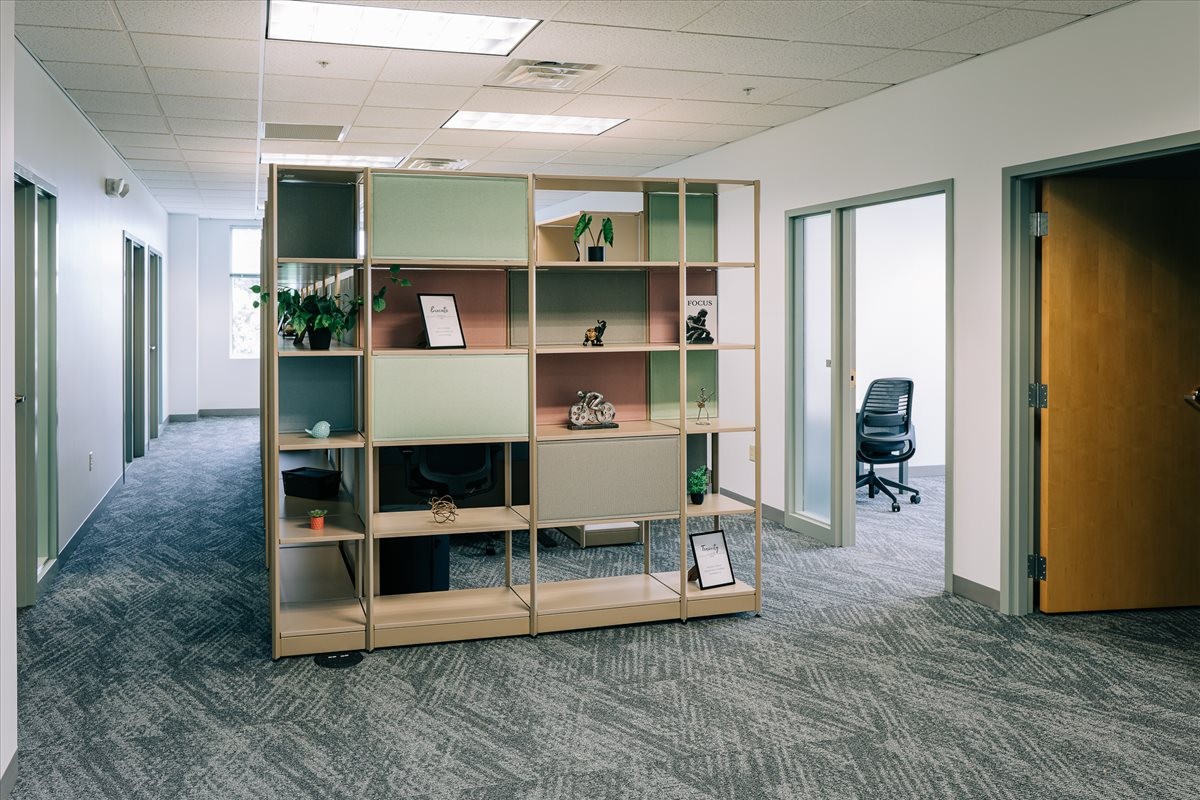 Spacious communal area at 330 Innovation Boulevard, 2nd Floor featuring a modern modular shelving unit and greenery.