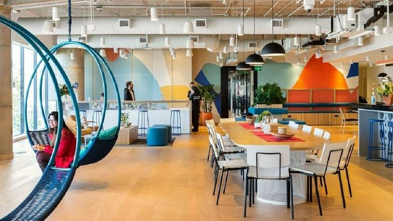 Vibrant communal area of 336, Pinheiros, R. Butantã, Sao Paulo featuring hanging swing chairs and colorful murals.