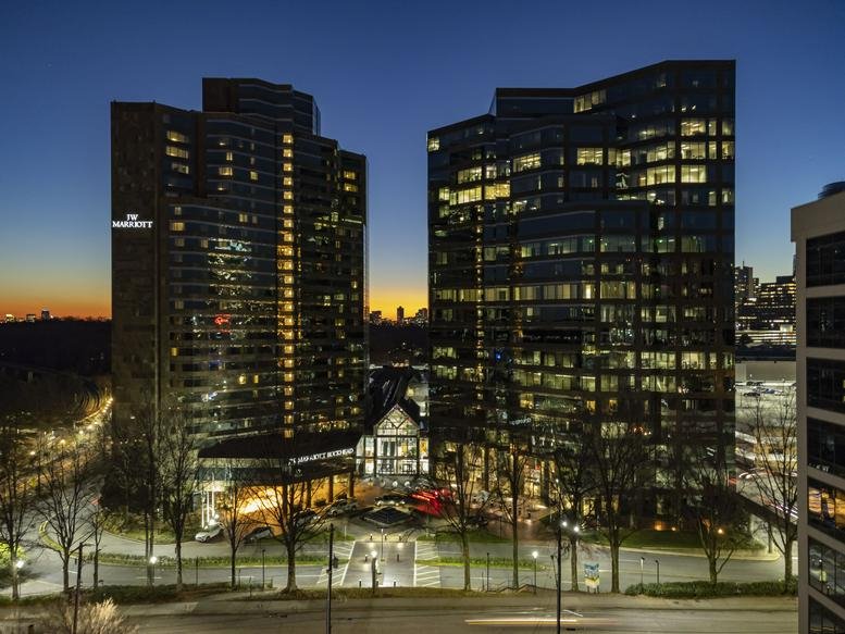 Exterior view of the illuminated twin towers at 3399 Peachtree Road Northeast in Buckhead.