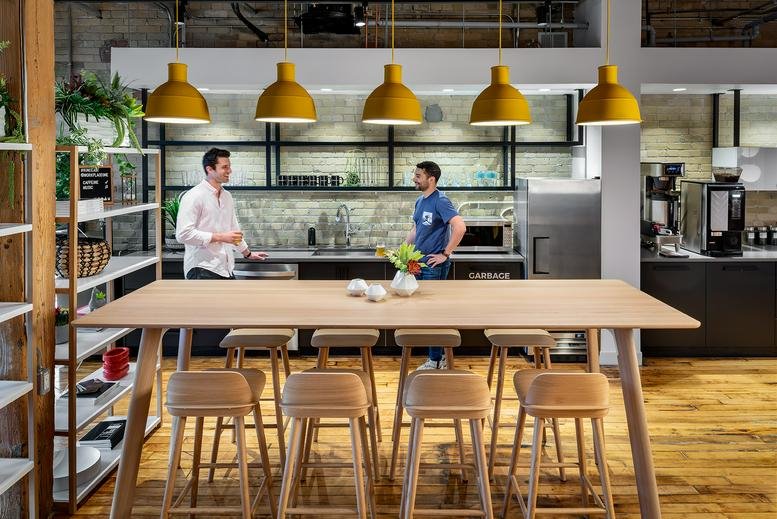 Spacious communal kitchen and dining area at 340 King Street East with yellow pendant lights.