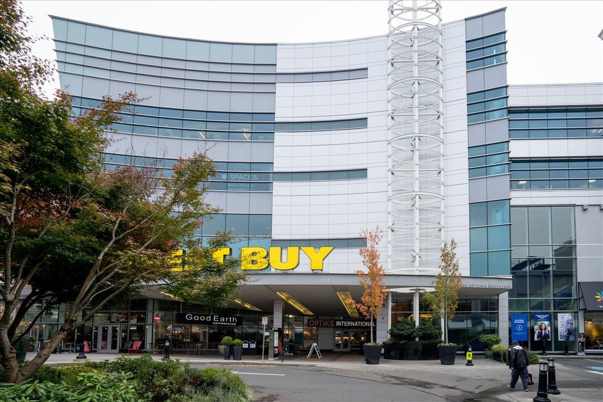 Exterior view of the multi-story 3450 Uptown Boulevard building featuring a glass facade.