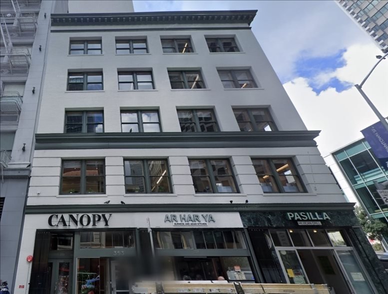 Wide exterior view of the multi-story white office building at 353 Kearny Street.