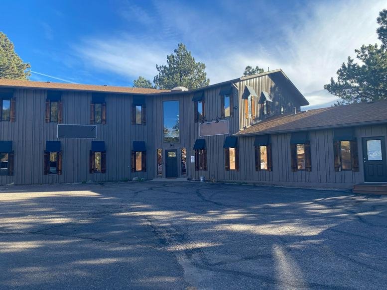 Exterior of the wood-sided office building at 3540 Evergreen Parkway.